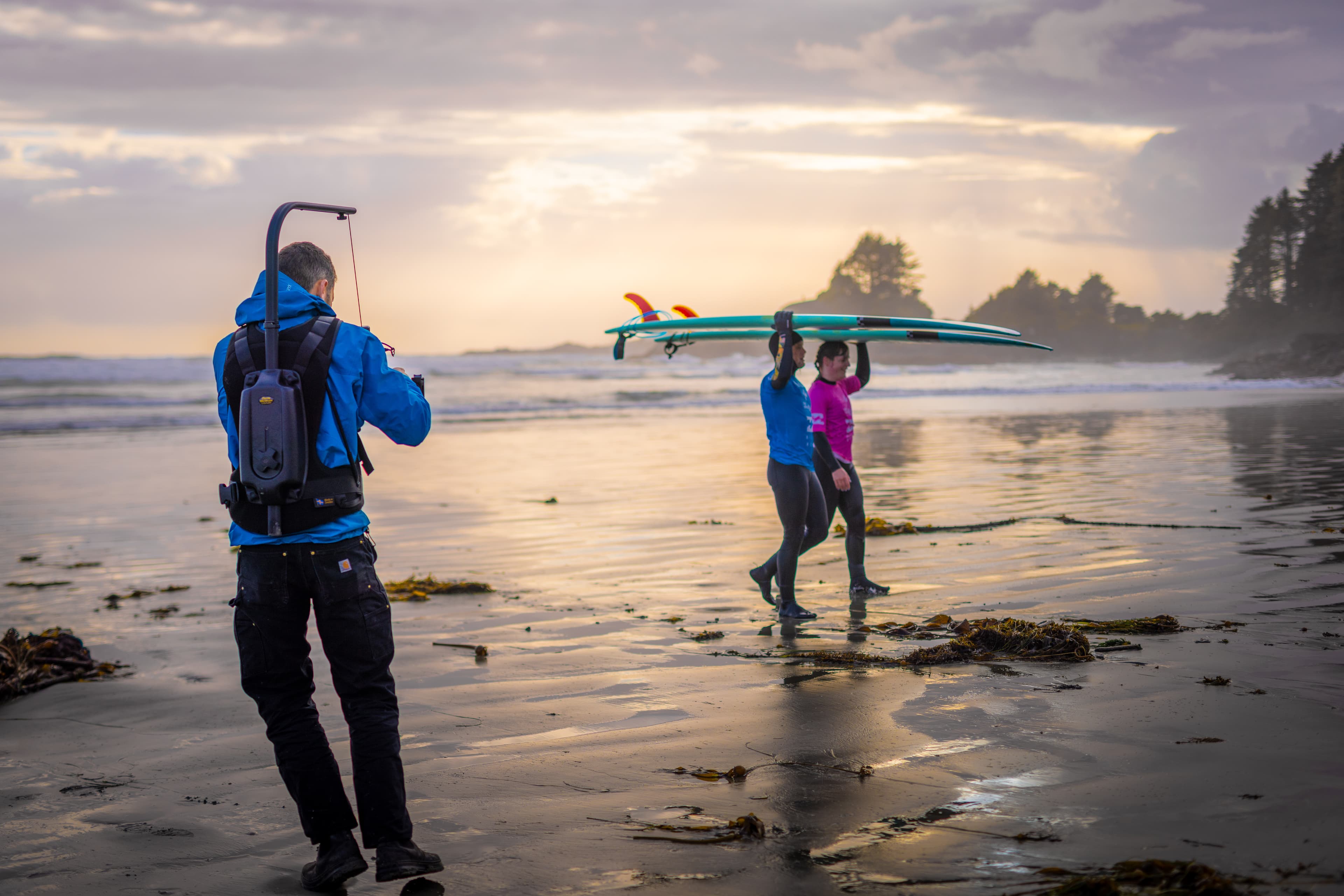 Benjamin filming on the beach at sunset
